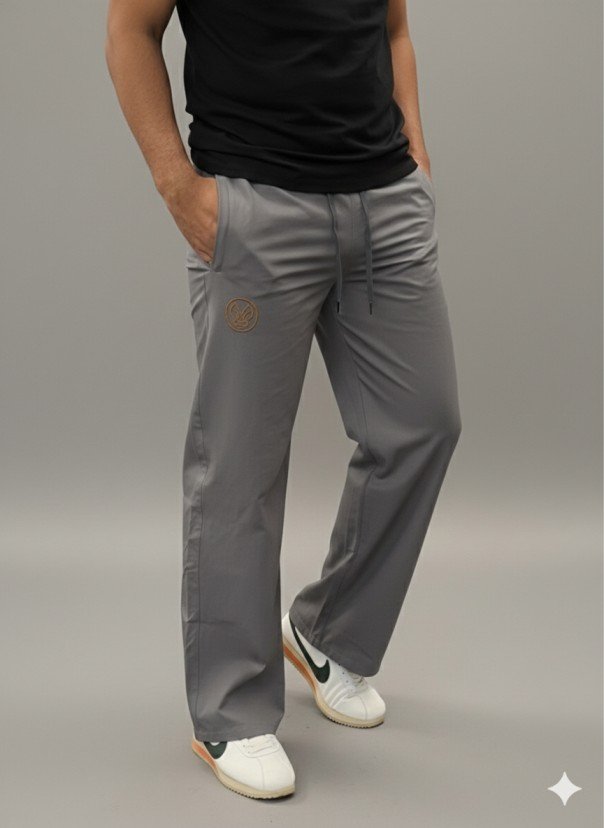 Men wearing grey straight fit track pants with elastic waistband